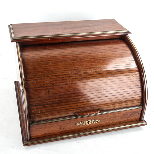 1003 - A mahogany tambour-front desktop stationery cabinet, circa 1900, with applied brass banding and draw... 