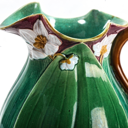 1009 - Minton Majolica pottery jug, lily flower and leaf moulded body, serial no. 1228, height 22cm