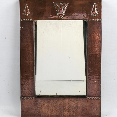 1014 - A Liberty & Co, Arts and Crafts mirror, with planished copper frame, label on reverse, 46 x 30.5cm