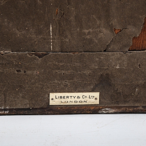 1014 - A Liberty & Co, Arts and Crafts mirror, with planished copper frame, label on reverse, 46 x 30.5cm