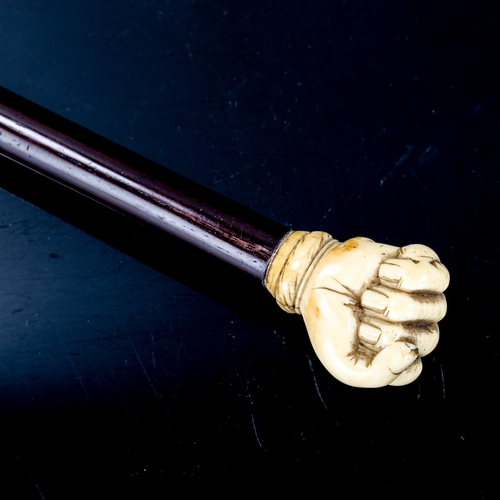 1093 - A marine ivory-handled walking stick, carved in the form of a fist holding a snake