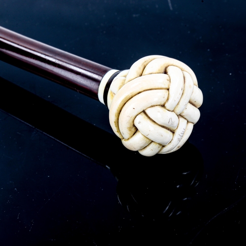 1094 - An exotic wood walking stick, with relief carved ivory crown knot design handle