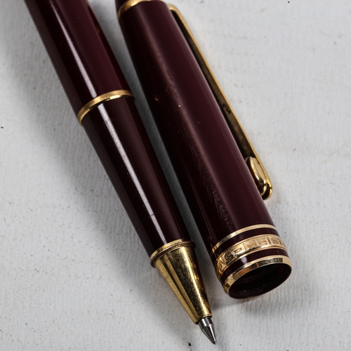 1121 - MONT BLANC - a burgundy Meisterstuck Classique ballpoint pen, length 14cm