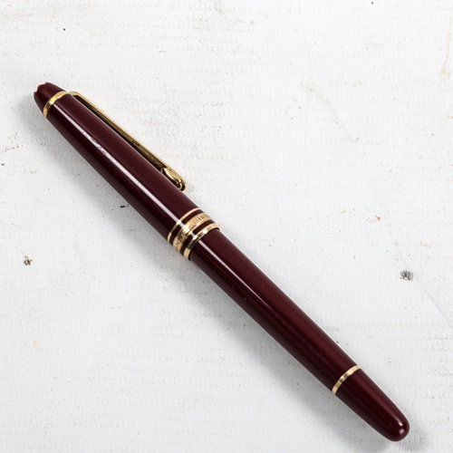 1121 - MONT BLANC - a burgundy Meisterstuck Classique ballpoint pen, length 14cm