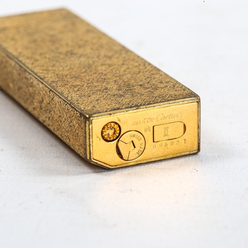 1122 - MUST DE CARTIER - a Vintage gold plated lighter, textured decoration, serial no. 09602T, height 7cm,... 