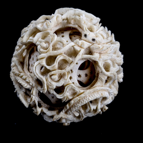 1128 - A Chinese carved ivory puzzle ball, late 19th/early 20th century, diameter 5cm