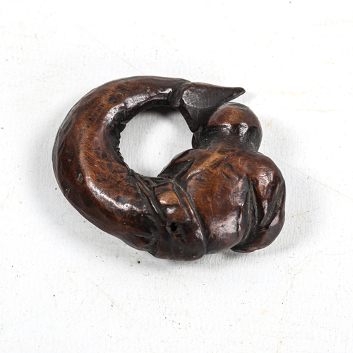 1134 - Japanese carved wood netsuke, in the form of a fish swallowing a man, Meiji Period, length 5.5cm