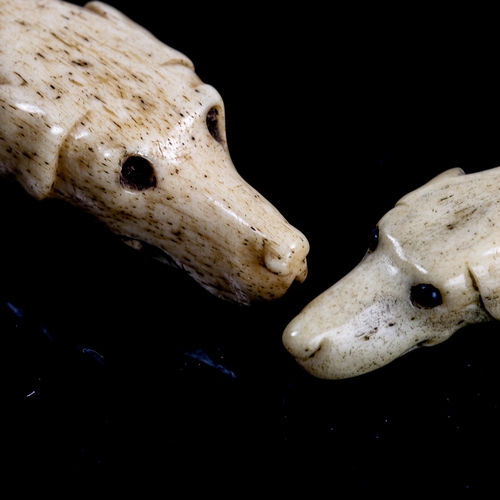 1135 - 2 Antique carved bone dog's head design whistles, 18th or 19th century, length 7cm and 4.5cm