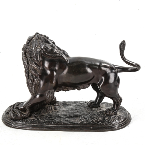 1154 - Victorian bronze patinated spelter sculpture, lion with a snake, length 21cm