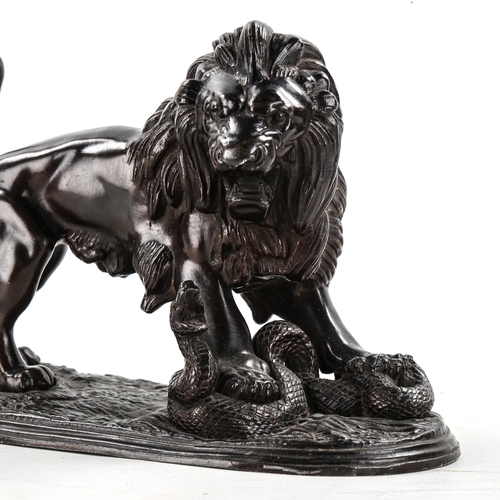 1154 - Victorian bronze patinated spelter sculpture, lion with a snake, length 21cm