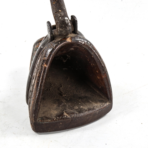 1175 - An Antique Mongolian relief carved wood stirrup, with steel-mount and leather strap