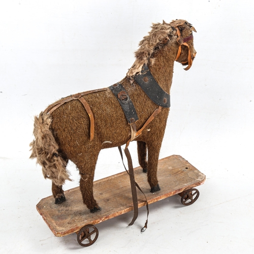 1182 - A Victorian soft toy pull-along horse on wheeled wooden base, length 29cm