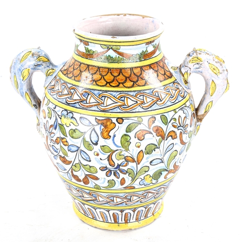 1193 - An Italian tin-glazed pottery wine vessel, with painted decoration and spout, height 22cm