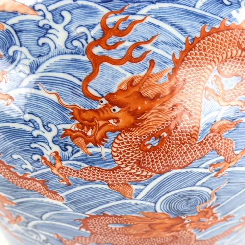 1205 - A Chinese blue and red painted porcelain vase, with dragon and sea design, seal mark, height 34cm