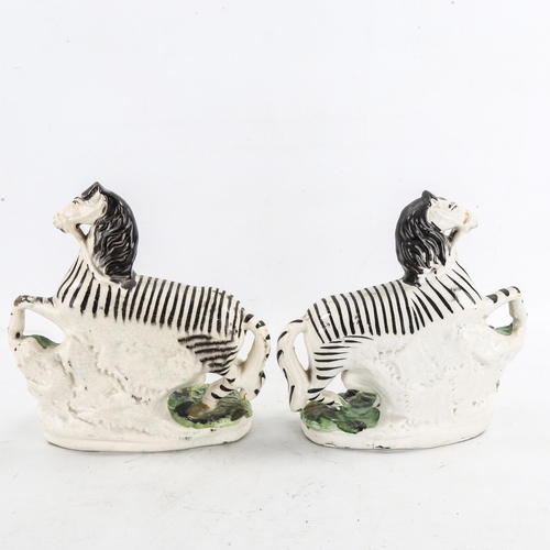 1221 - A pair of 19th century Staffordshire Pottery zebra, height 22cm