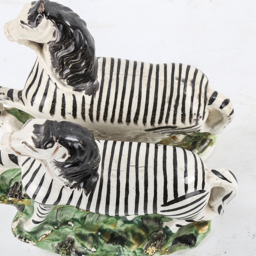 1221 - A pair of 19th century Staffordshire Pottery zebra, height 22cm