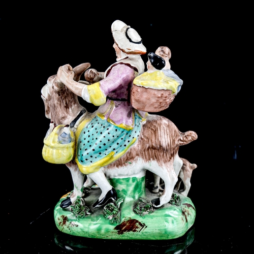 1226 - A 19th century Staffordshire Pottery figure of a woman and children on a goat, height 13.5cm