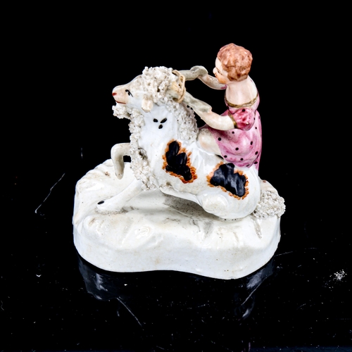 1235 - A 19th century Staffordshire Pottery figure of a girl riding a goat, height 9cm