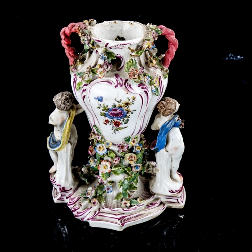 1242 - 19th century Continental porcelain floral encrusted vase, supported by 4 cherubs, height 17.5cm