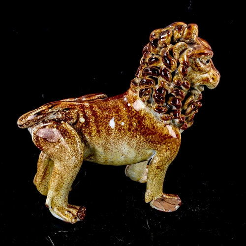 1258 - A glazed pottery standing lion figure, early 20th century, height 19cm