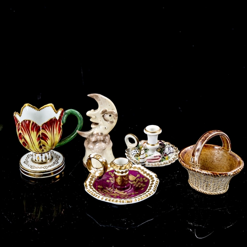 1260 - A group of miniature cabinet china, including a moon design candle snuffer, miniature chamber sticks... 