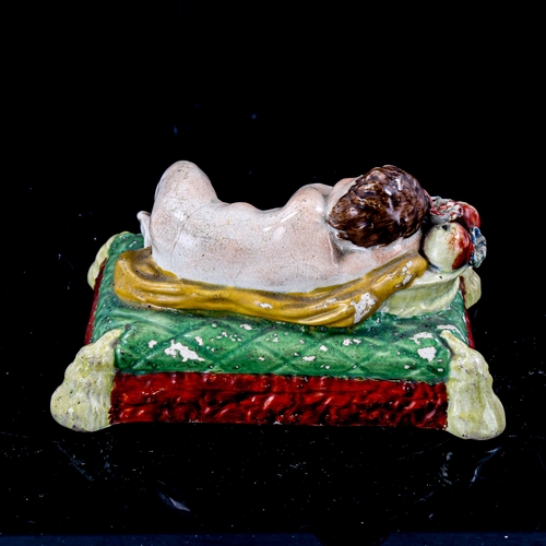 1261 - 19th century Staffordshire Pearlware figure, cherub sleeping on a cushion, length 13cm