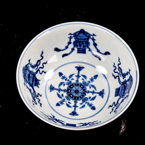 1272 - A Chinese porcelain bowl, with painted enamel panels, in iron red surround and blue painted interior... 