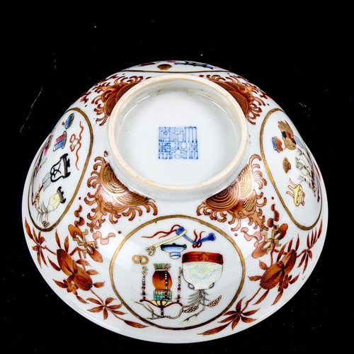 1272 - A Chinese porcelain bowl, with painted enamel panels, in iron red surround and blue painted interior... 