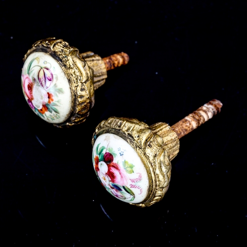 1290 - A pair of 19th century relief cast bronze handles, with floral painted porcelain inset domed panels,... 