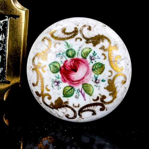 1293 - A floral painted porcelain handle, diameter 3.5cm, a bronze lock escutcheon and cover, and an engrav... 