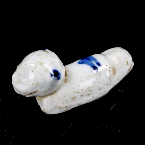 1320 - A miniature Chinese 18th century blue and white glazed porcelain whistle, in the form of a sleeping ... 