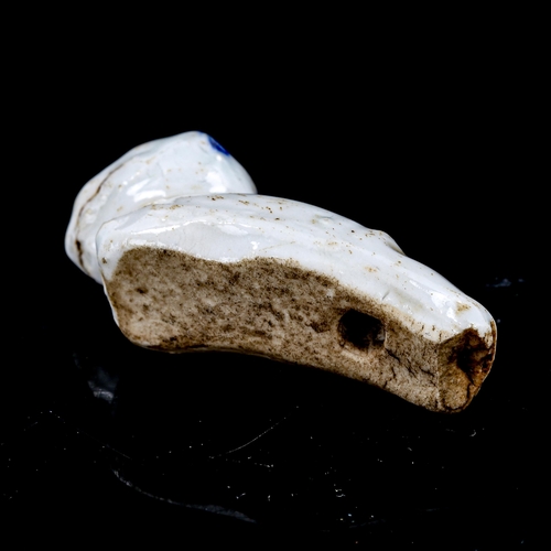 1320 - A miniature Chinese 18th century blue and white glazed porcelain whistle, in the form of a sleeping ... 