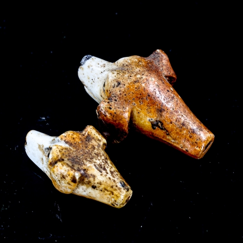 1322 - 2 similar 19th century porcelain whistles, in the form of dog's heads, length 4.5cm and 3.5cm (2)