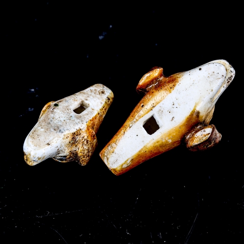 1322 - 2 similar 19th century porcelain whistles, in the form of dog's heads, length 4.5cm and 3.5cm (2)