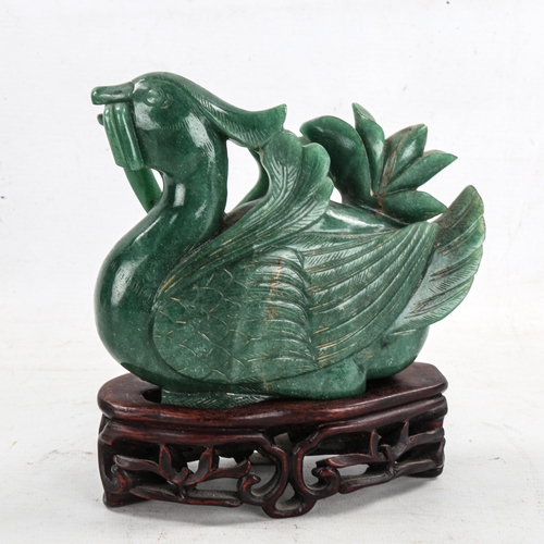 1367 - A Chinese carved greenstone bird, on hardwood stand, height 16cm