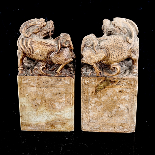 1375 - A pair of Chinese soapstone seals, surmounted by Dogs of Fo, height 18cm