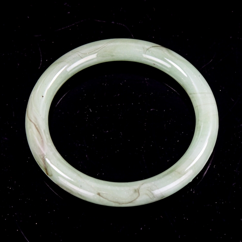 1381 - A polished jade slave bangle, band width 10mm, internal diameter 60mm, weight 46g