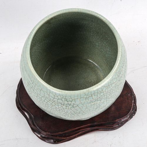 1405 - A Chinese celadon crackle glaze jardiniere, height 15cm, overall diameter 19cm, on hardwood stand