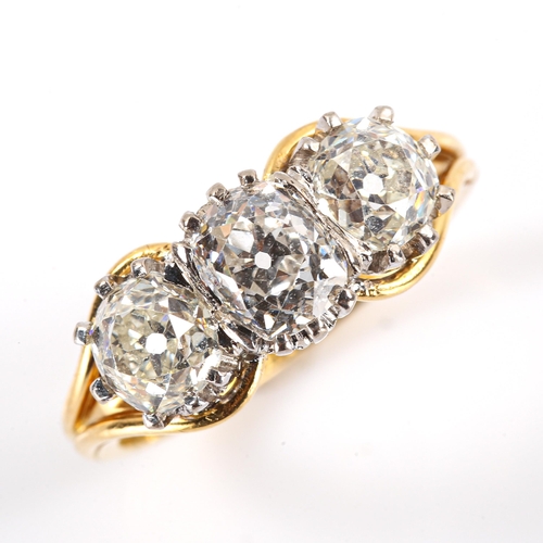 104 - A late 20th century 18ct white and yellow gold 3-stone diamond ring, claw-set with cushion old cut a... 