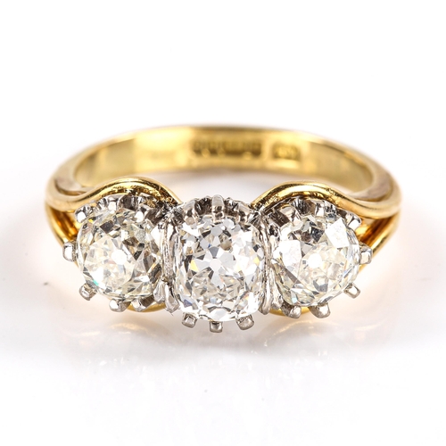 104 - A late 20th century 18ct white and yellow gold 3-stone diamond ring, claw-set with cushion old cut a... 