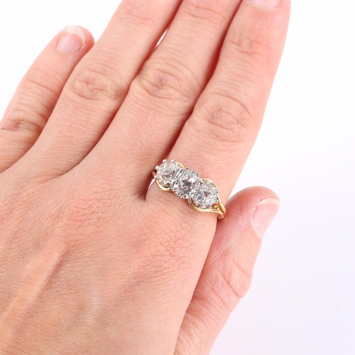 104 - A late 20th century 18ct white and yellow gold 3-stone diamond ring, claw-set with cushion old cut a... 