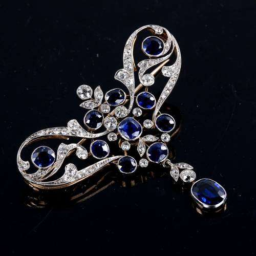 215 - A large Edwardian Art Noueau sapphire and diamond pendant / brooch, unmarked gold openwork settings ... 