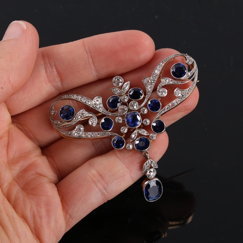 215 - A large Edwardian Art Noueau sapphire and diamond pendant / brooch, unmarked gold openwork settings ... 