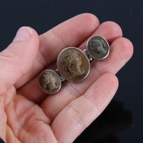 217 - A Victorian triple lava cameo panel brooch, depicting three female profiles, unmarked white metal se... 