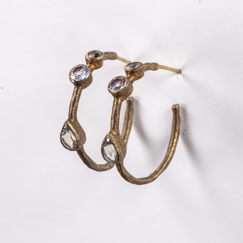 219 - A modern pair of silver gilt moonstone hoop earrings, textured settings with stud fittings and round... 