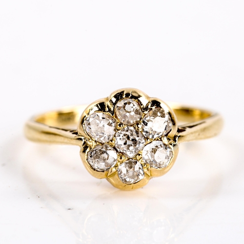 220 - A Victorian 18ct gold diamond round cluster flowerhead ring, set with old cut diamonds, total diamon... 