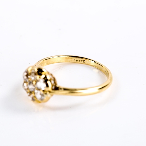 220 - A Victorian 18ct gold diamond round cluster flowerhead ring, set with old cut diamonds, total diamon... 