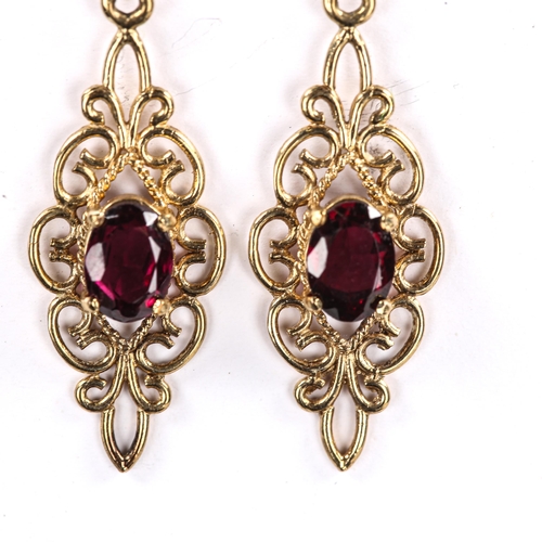 222 - A pair of modern 9ct gold garnet drop stud earrings, open wirework design with oval mixed cut garnet... 