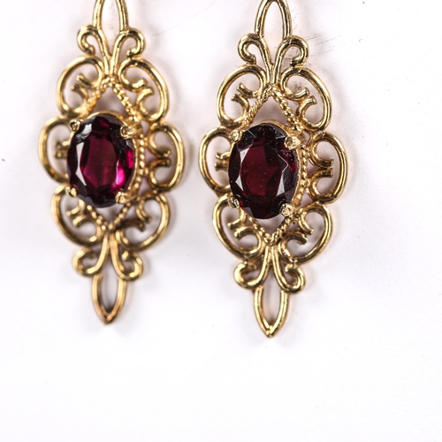 222 - A pair of modern 9ct gold garnet drop stud earrings, open wirework design with oval mixed cut garnet... 