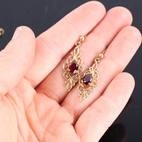 222 - A pair of modern 9ct gold garnet drop stud earrings, open wirework design with oval mixed cut garnet... 